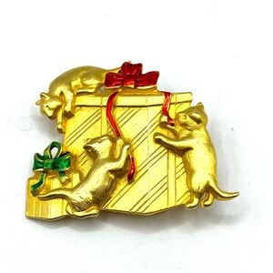 Elegant Gold Brooch with Playful Cats and Red Accents Cats Unwrapping Presents